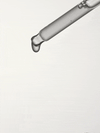 A clear glass dropper releasing a droplet of transparent liquid.